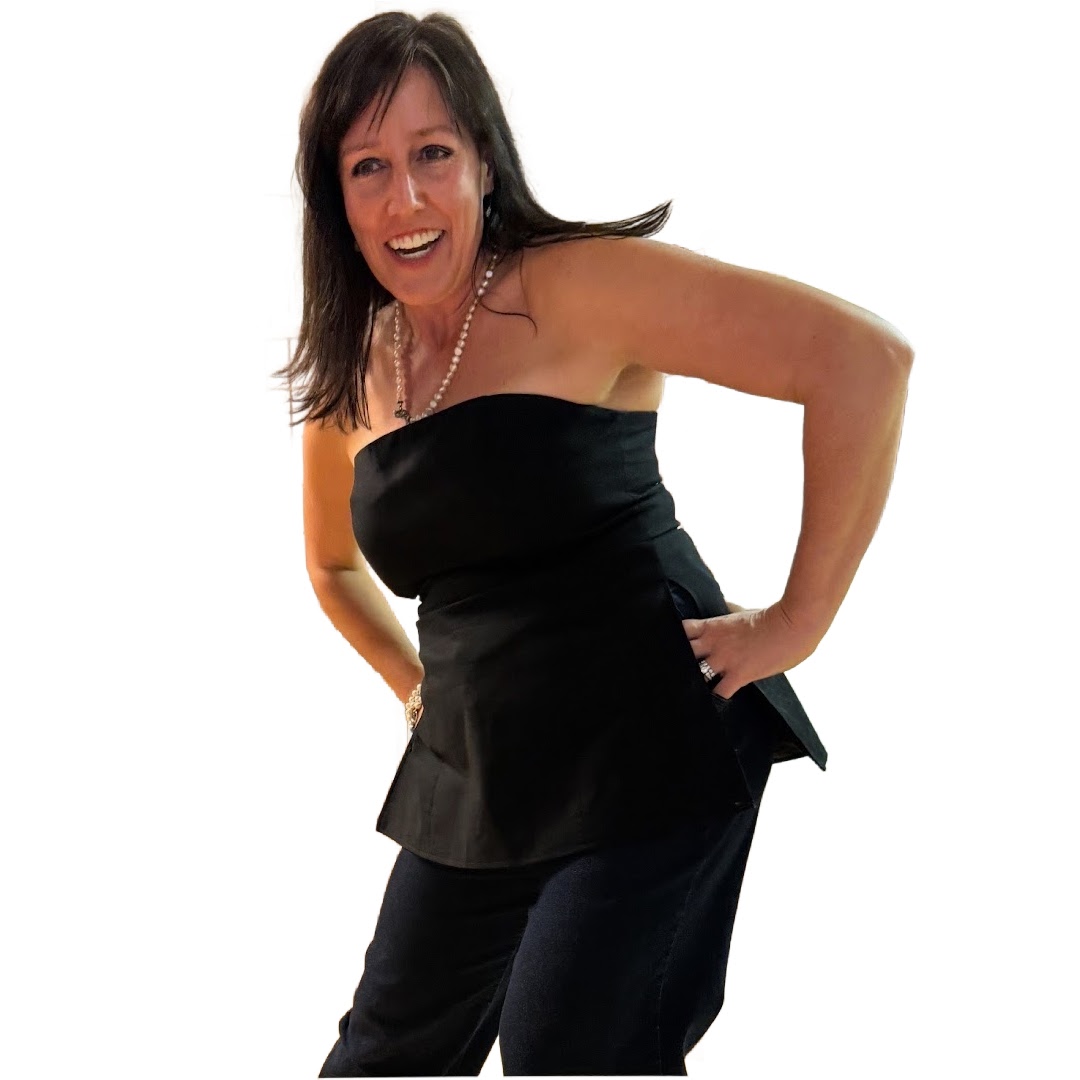 Laura West in a black strapless top and pants posing with hands on hips. Reiki master teacher. Laura West in a black strapless top and pants posing with hands on hips. Reiki master teacher.